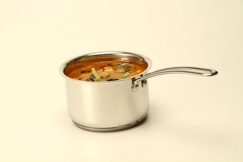 Free Close-up of South Indian sambar in a stainless steel pot on a white background. Stock Photo