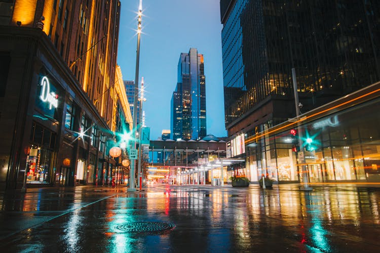 City Buildings With Lights Turned On During Night Time