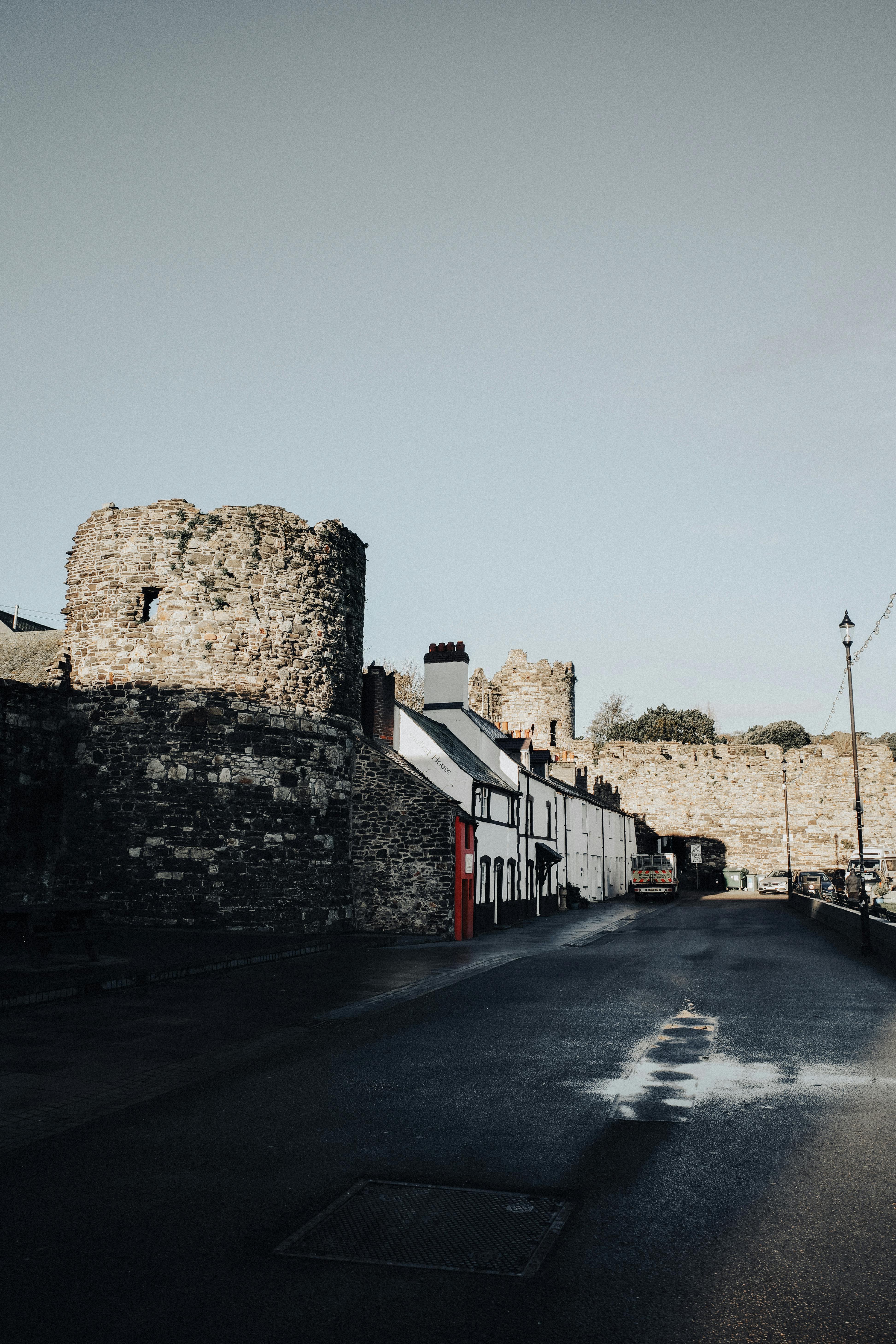 Explore the medieval stone walls of Conwy Castle, captured under a clear sky.