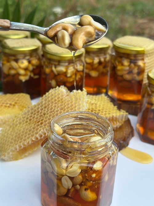 Free Jars of honey and nuts with honeycomb, showcasing rich textures and natural sweetness. Stock Photo