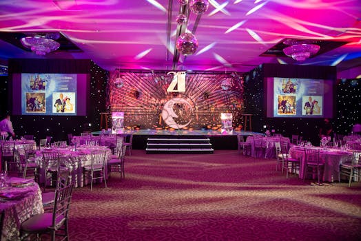 Vibrant event hall set up for a themed dinner with elegant decorations and lighting.