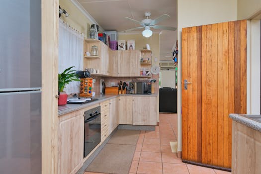 Cozy kitchen with wooden cabinets, appliances, and natural light streaming in.