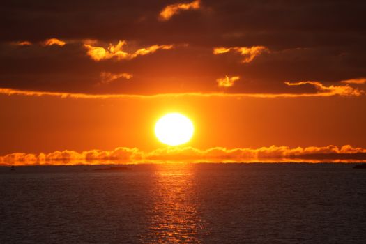 A breathtaking sunset over the ocean with dramatic clouds and vivid colors.