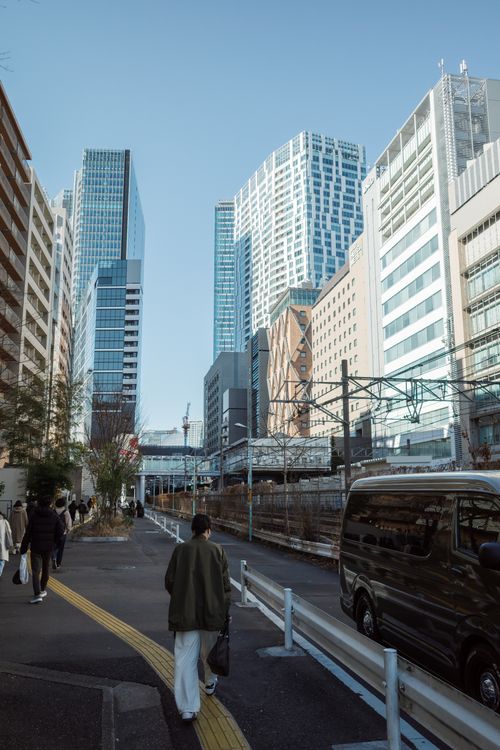 Free A vibrant street scene in Shibuya, Tokyo featuring modern skyscrapers and pedestrians. Stock Photo