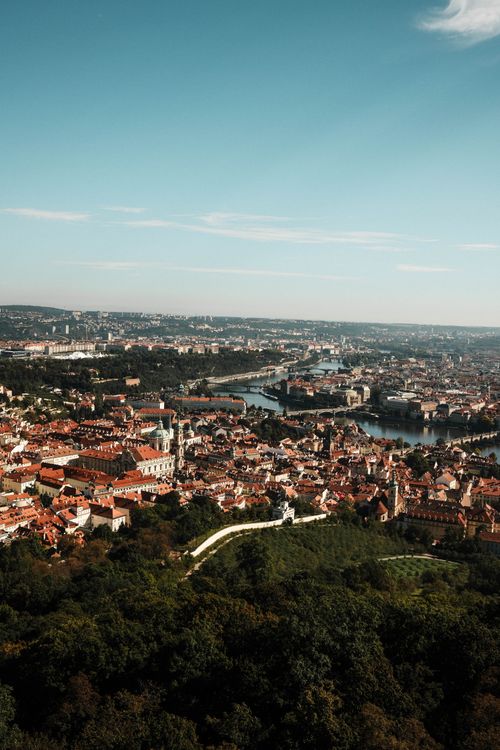 Free Stunning aerial view of Prague's historic cityscape with iconic red rooftops and Vltava River. Stock Photo
