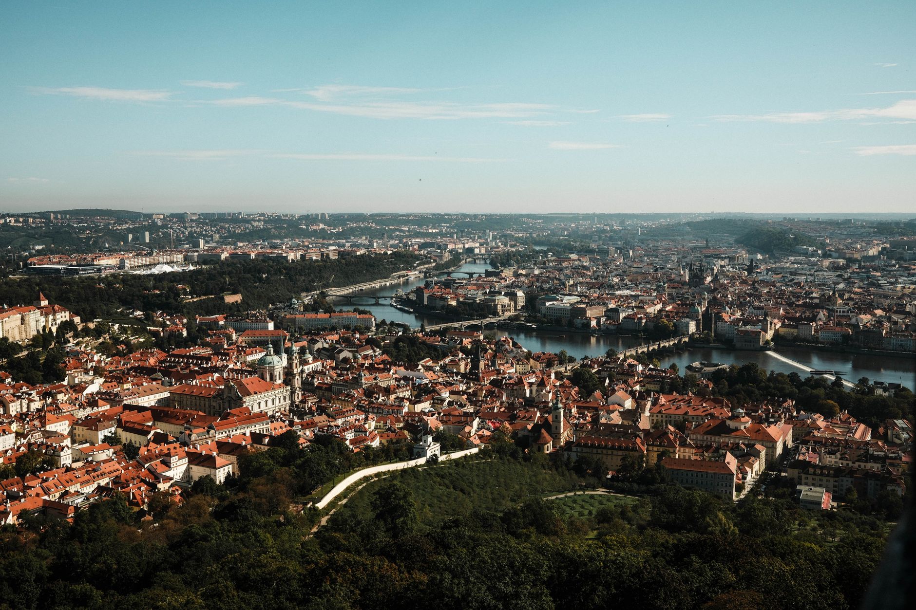 Stunning aerial vista of Prague showcasing the iconic Charles Bridge and Vltava River in the heart of the city.