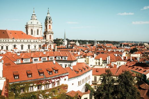 Explore the stunning cityscape of Prague with its iconic red rooftops and historical architecture.