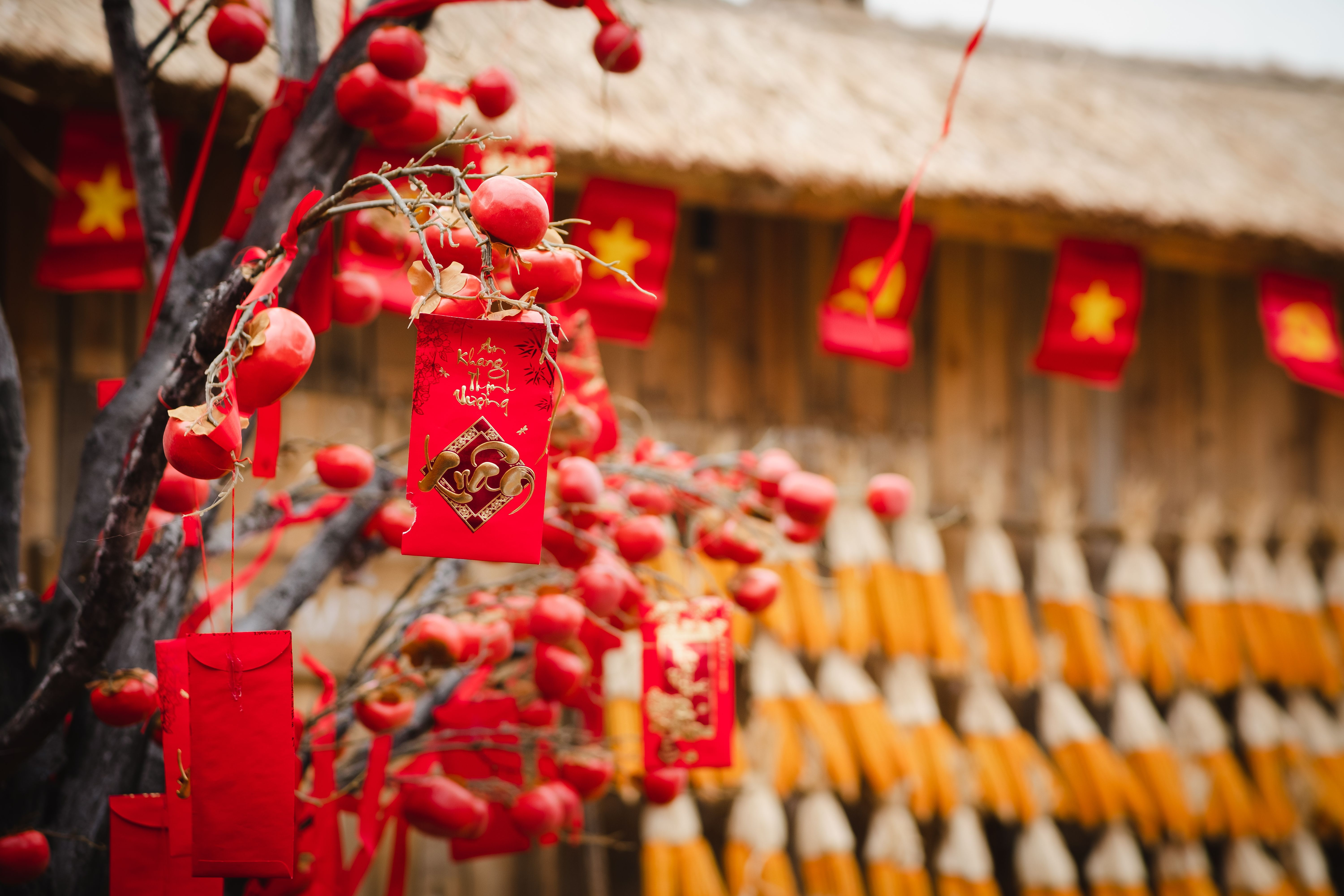 Colorful red envelopes and decorations adorn an outdoor setting for Lunar New Year celebration.