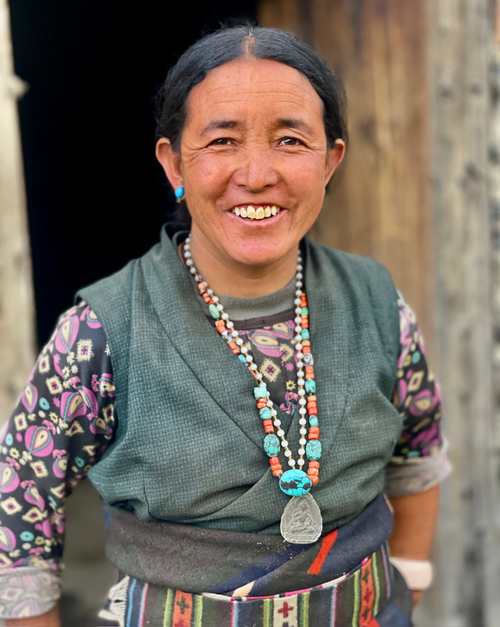 Free A smiling Nepali woman in traditional attire, showcasing cultural heritage in rural Nepal. Stock Photo