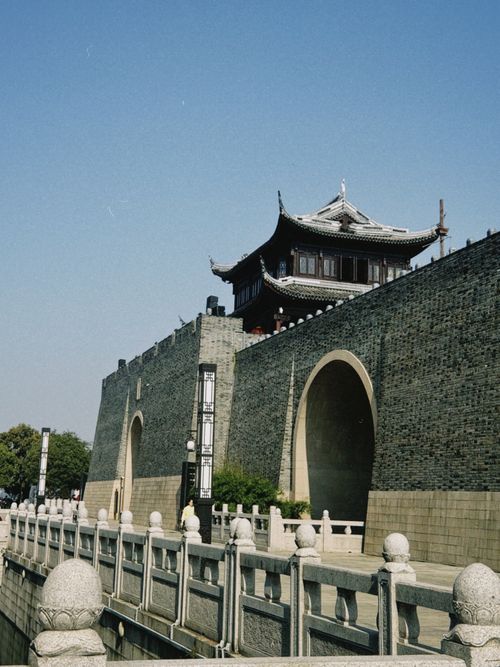 Free Traditional Chinese architectural structure on ancient stone wall under clear sky. Stock Photo