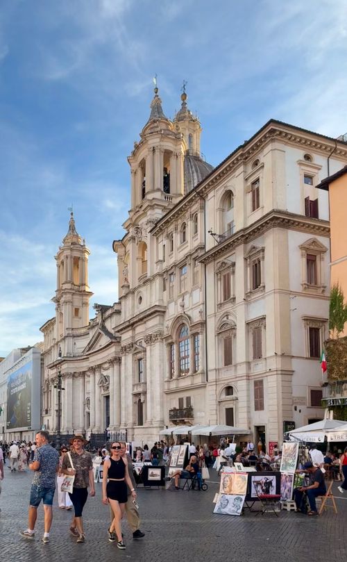 Free Bustling scene at Piazza Navona, Rome with stunning Baroque architecture and lively street vendors. Stock Photo