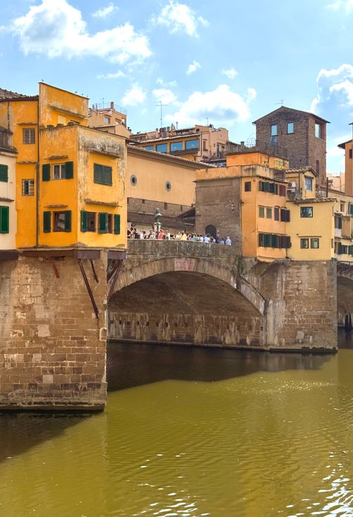 Free Charming view of Ponte Vecchio in Florence, Italy on a sunny day with vibrant architecture. Stock Photo