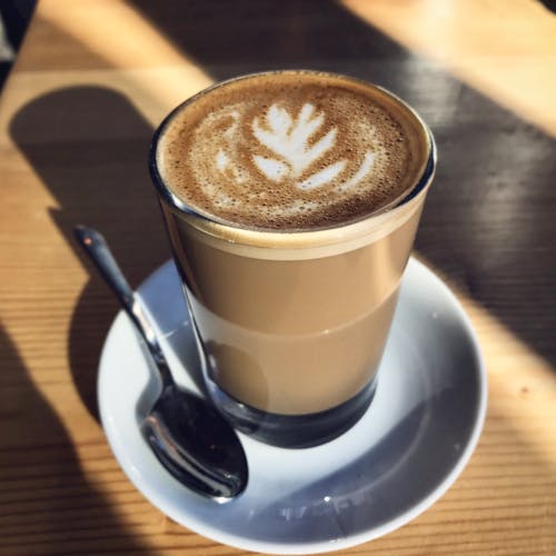 Free Cappuccino Filled Glass on Saucer Stock Photo