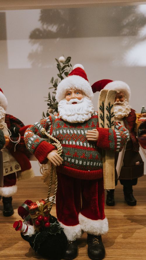Free Decorative Santa Claus figurine holding ski in festive setting, ideal for Christmas decor. Stock Photo