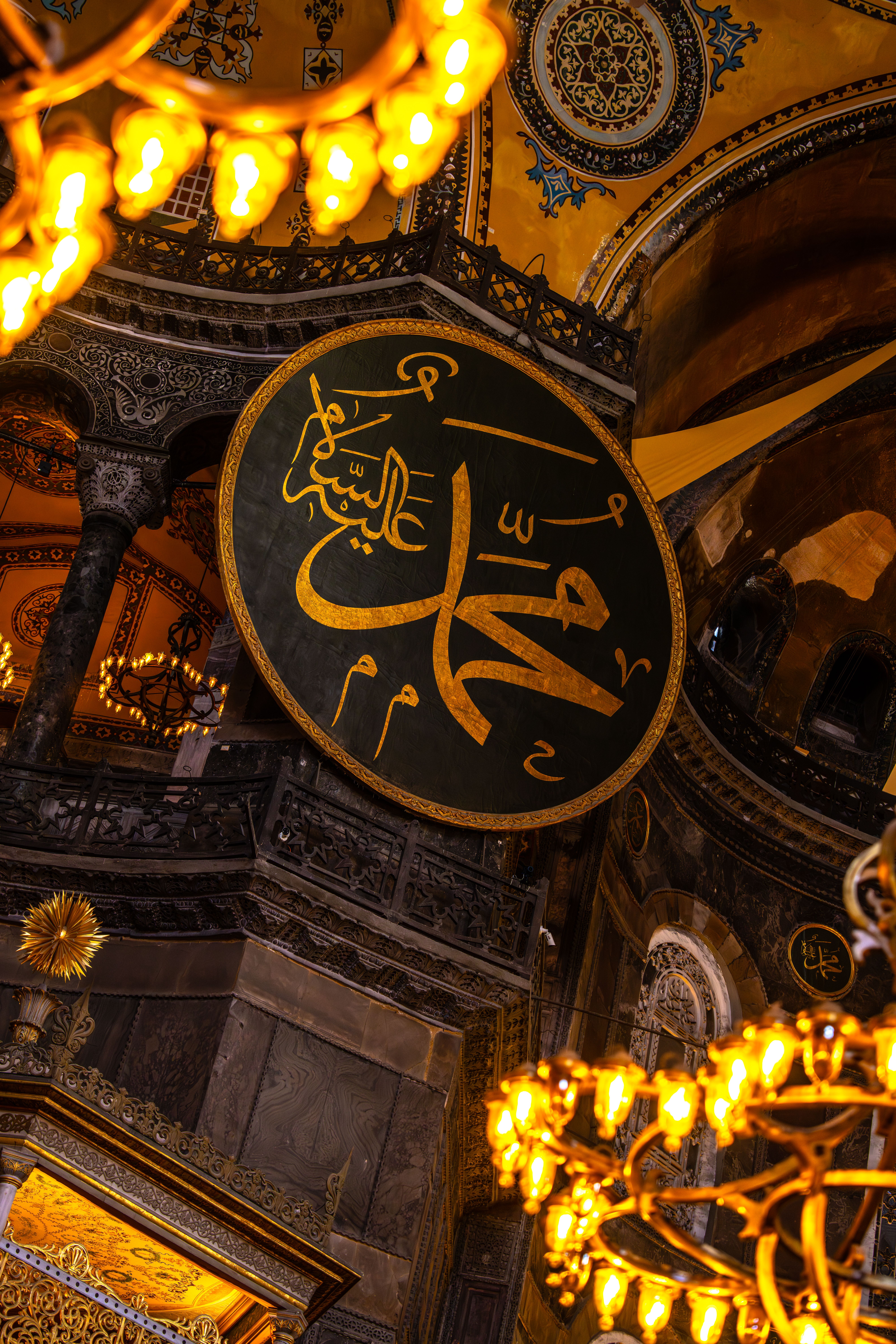 Golden intricate Islamic calligraphy inside the historic Hagia Sophia, Istanbul.