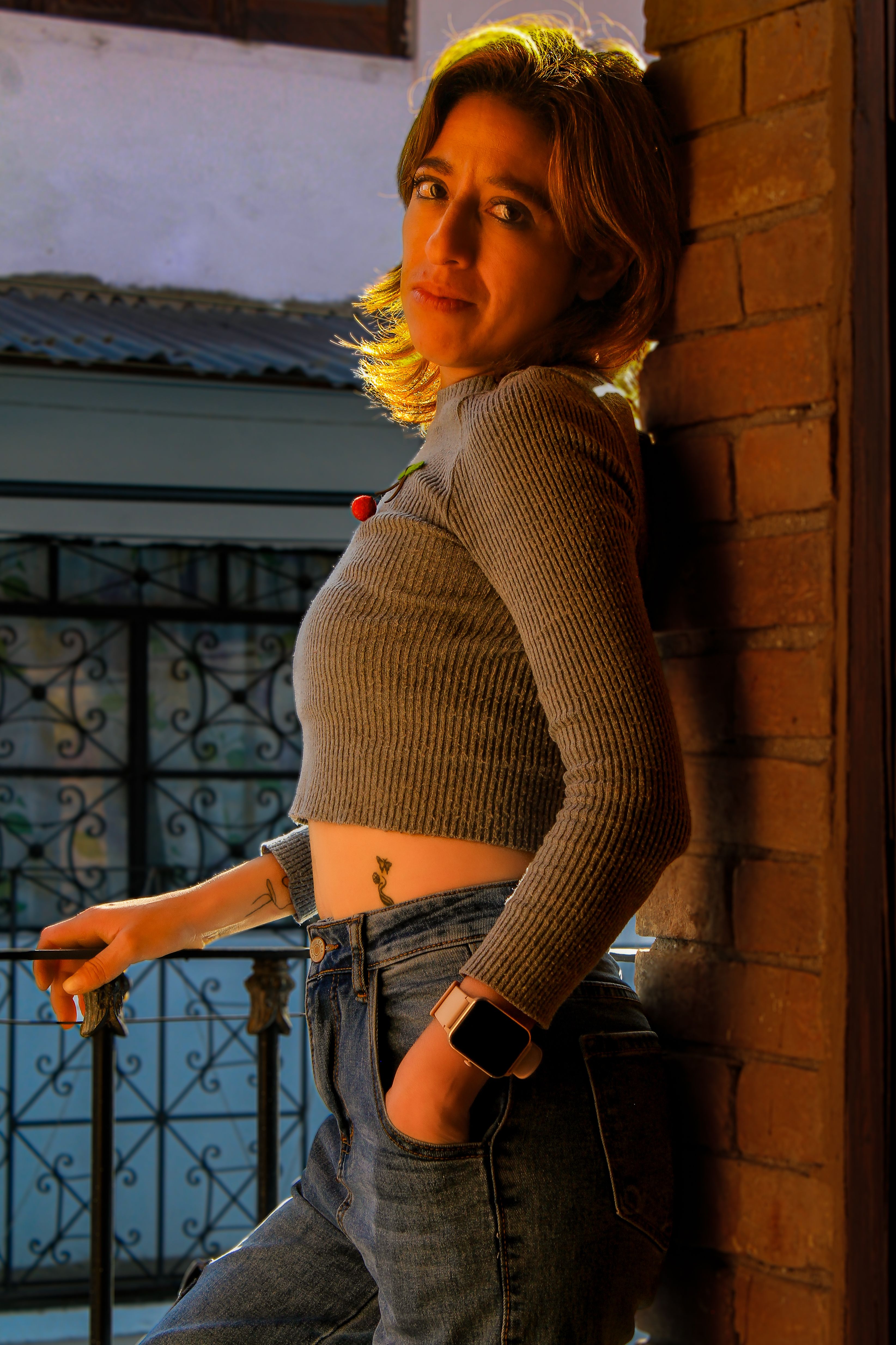 Stylish Woman Leaning Against a Brick Wall · Free Stock Photo