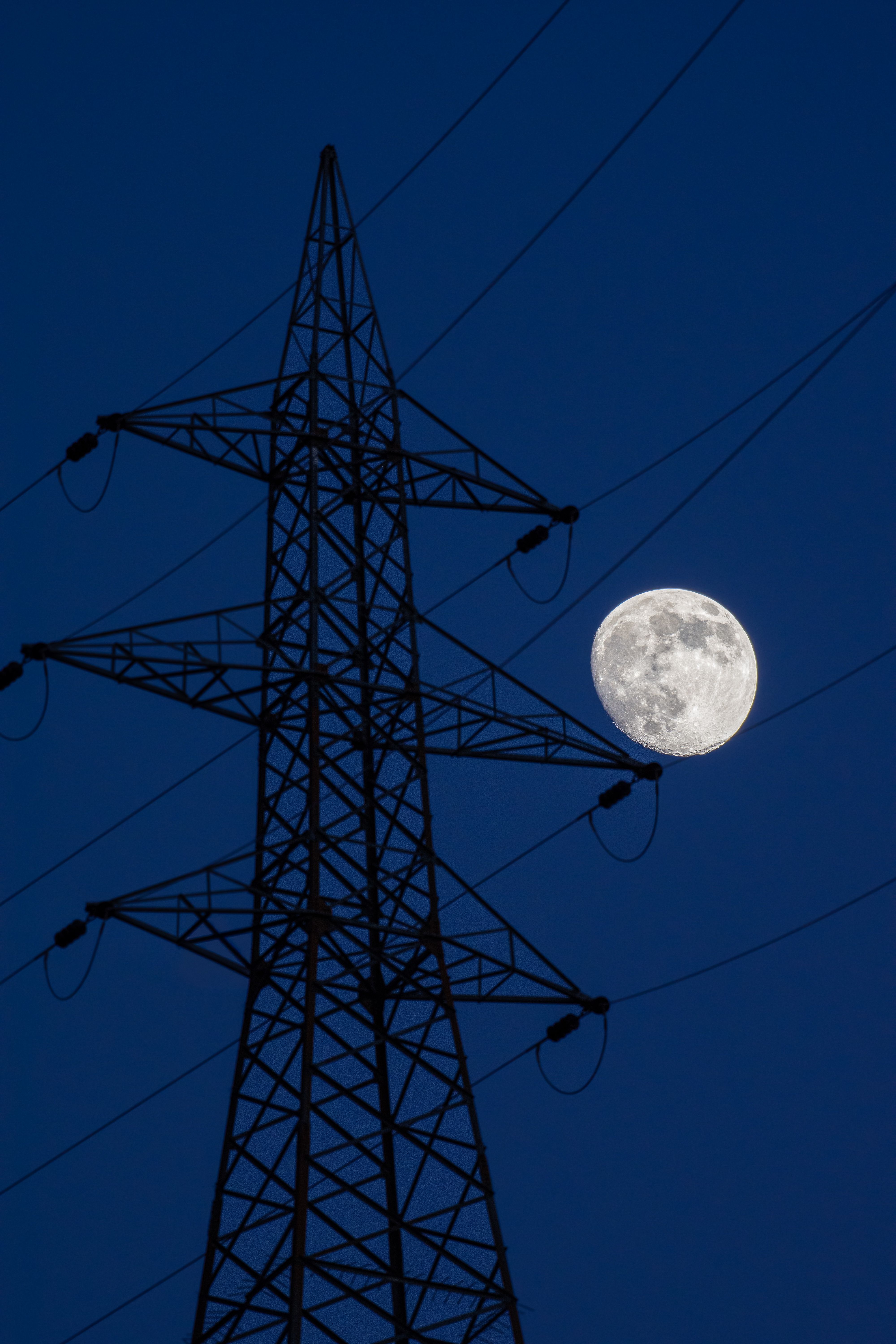 Power Lines Silhouetted Against Full Moon · Free Stock Photo