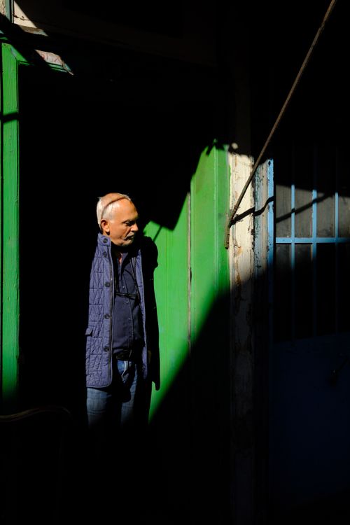 Free A man stands in the shadows of an alley in Bursa, Türkiye, highlighting contrast and urban atmosphere. Stock Photo