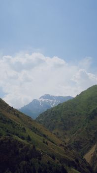Beautiful mountain view with snow-capped peaks under a clear blue sky.
