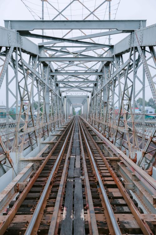 Free Symmetrical view of a steel railway bridge showcasing industrial design. Stock Photo