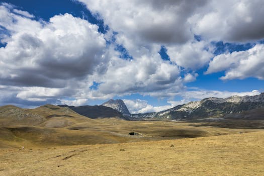 Breathtaking view of Gran Sasso mountains with dramatic clouds and vast landscapes.