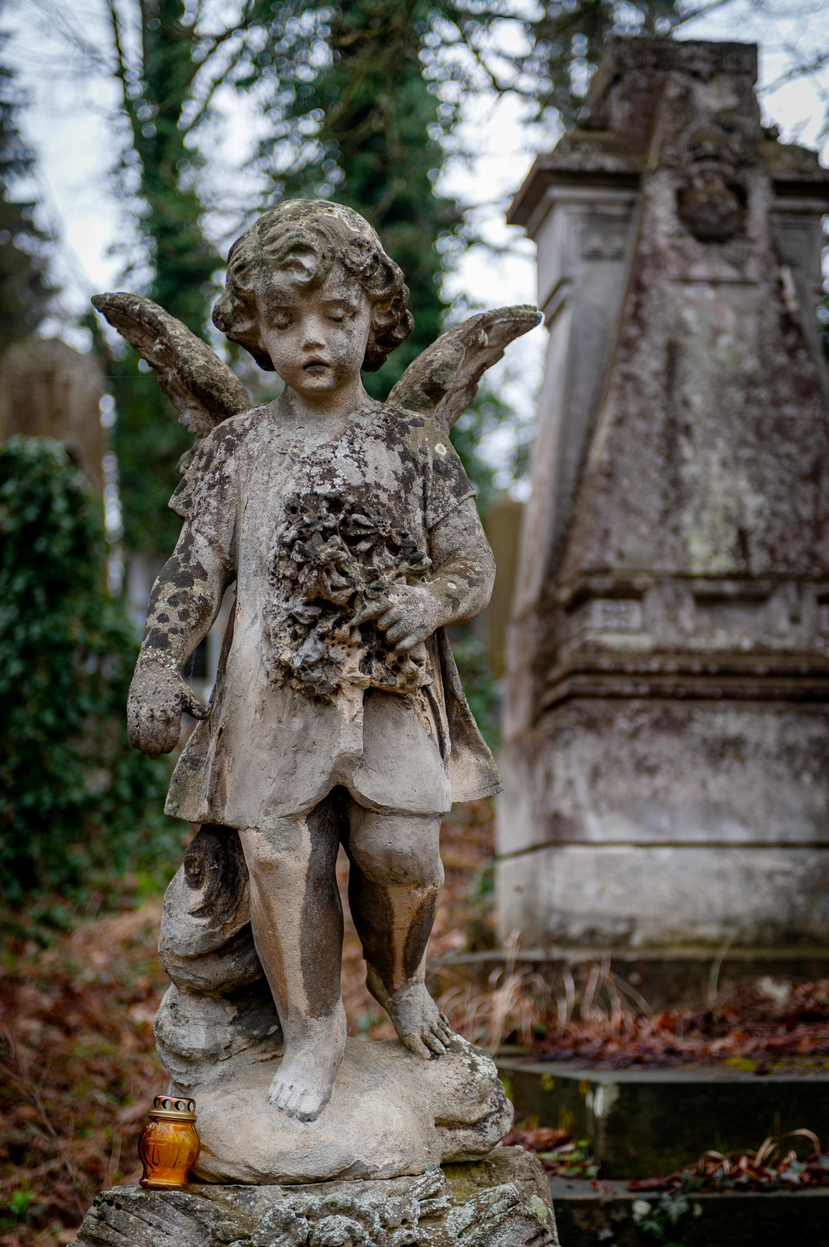 Stone Angel Statue between Trees and Plants · Free Stock Photo