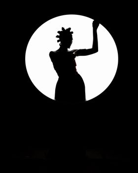 Artistic silhouette of a woman with traditional African hairstyle against a circular backdrop.