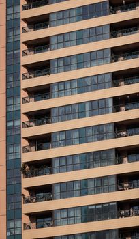 Close-up of a contemporary skyscraper showing exterior design and balconies.