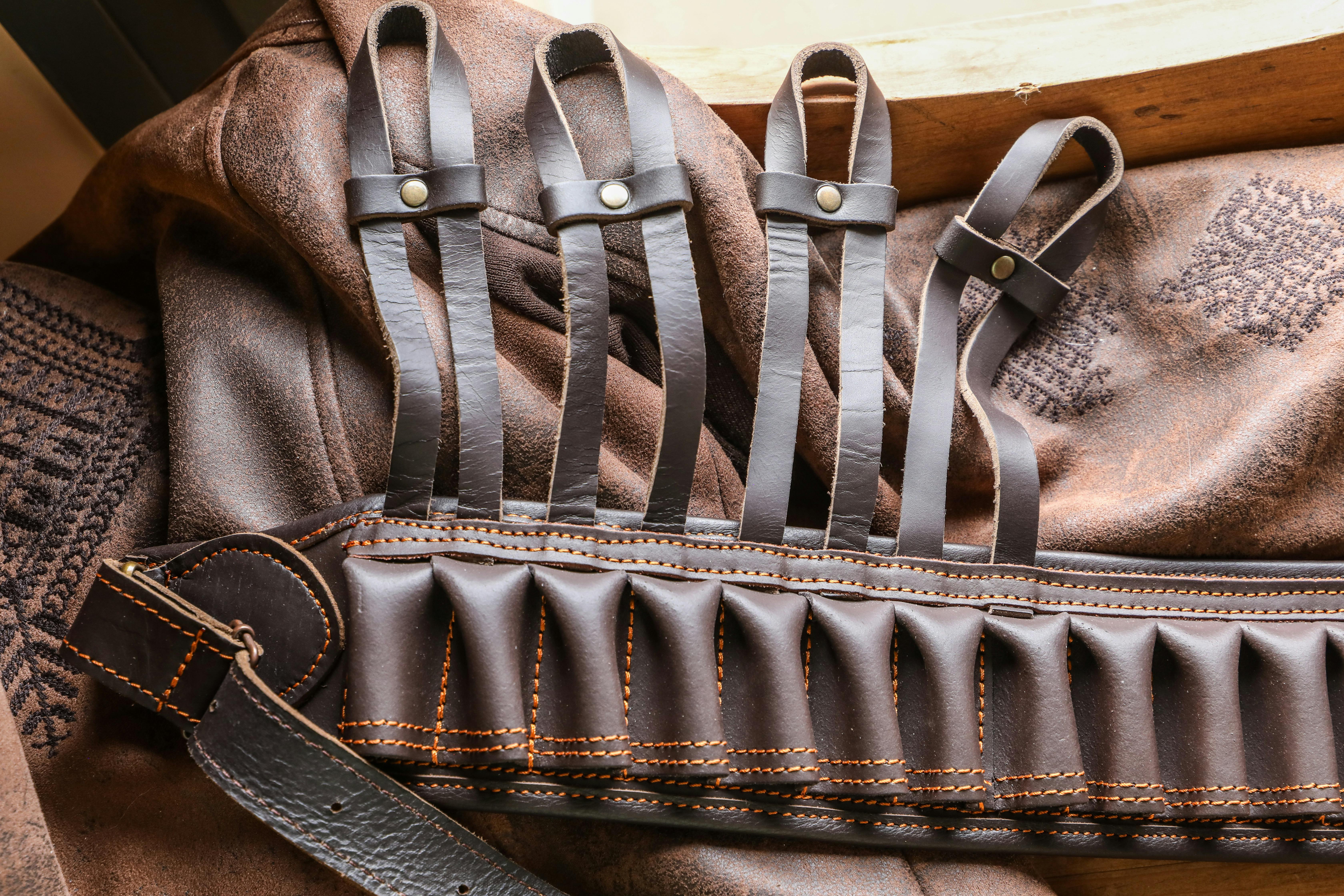 Detailed image of a leather bandolier with bullet slots on a textured leather surface.