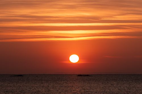 Free Capture of a vibrant sunrise over Cove Island Park in Stamford, Connecticut with a vivid orange sky. Stock Photo