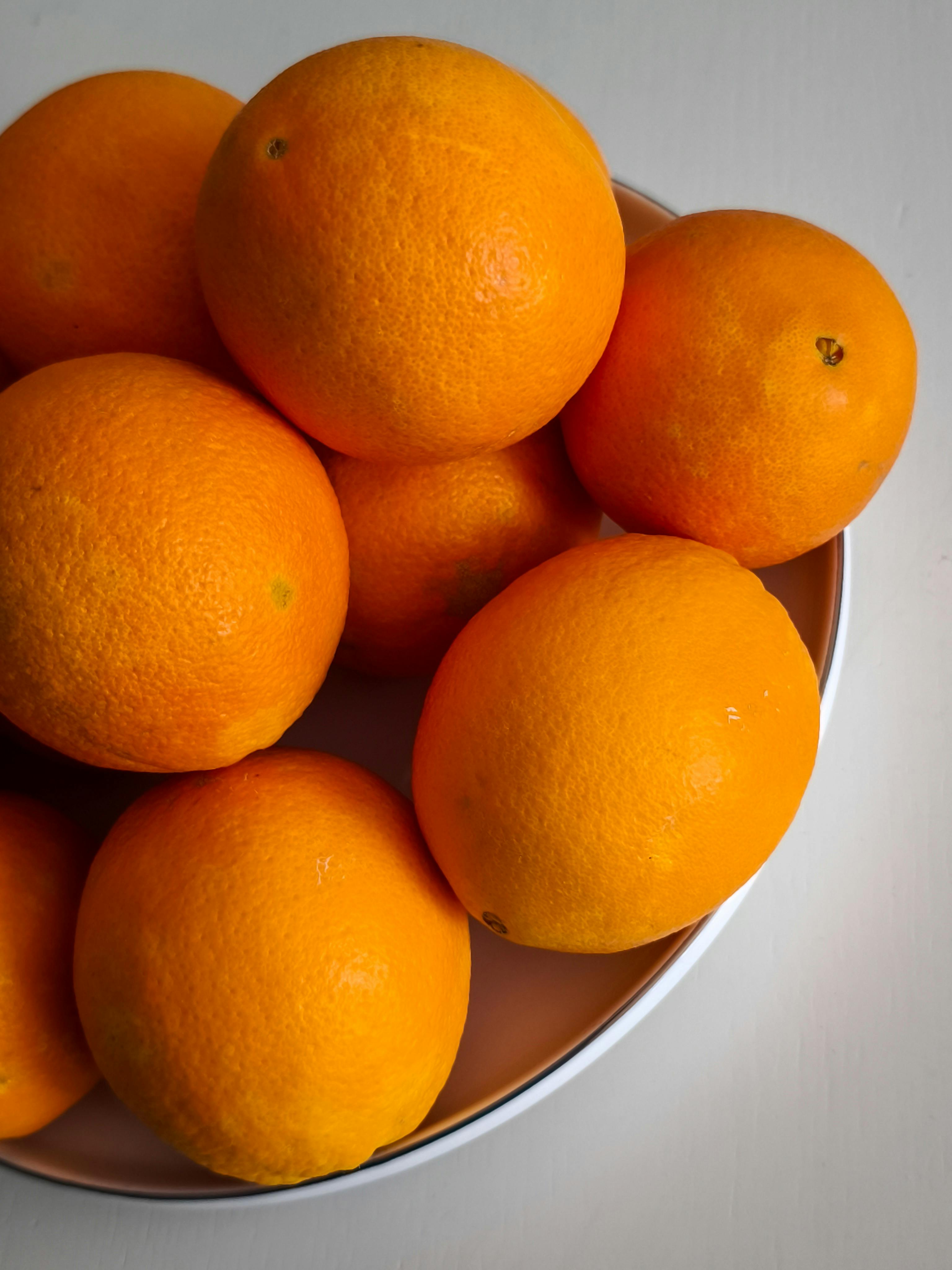 Bright and juicy oranges in a bowl, perfect for a fresh, healthy snack. Ideal for nature and food themes.