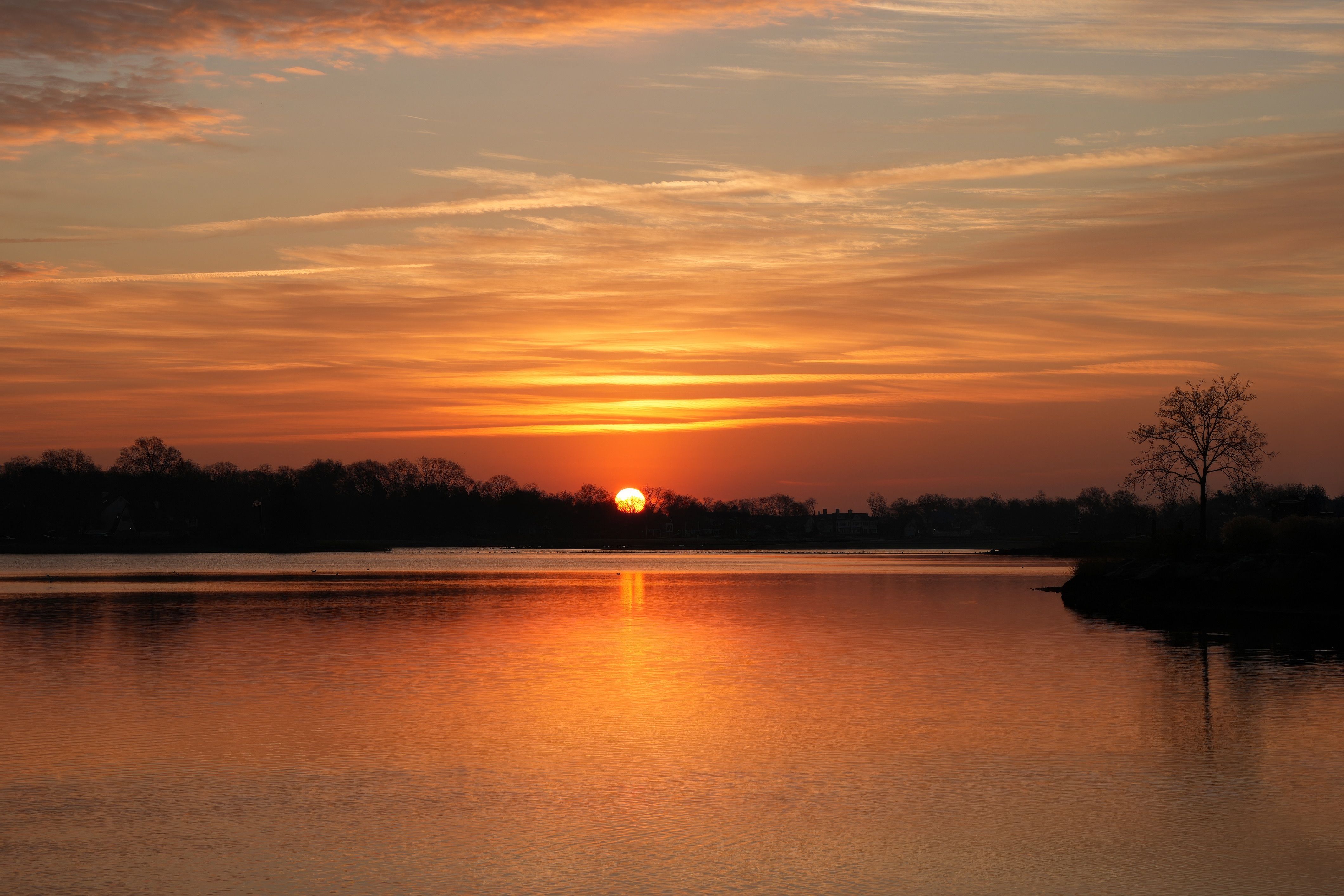 Serene Sunset Over Reflective Lake Waters · Free Stock Photo