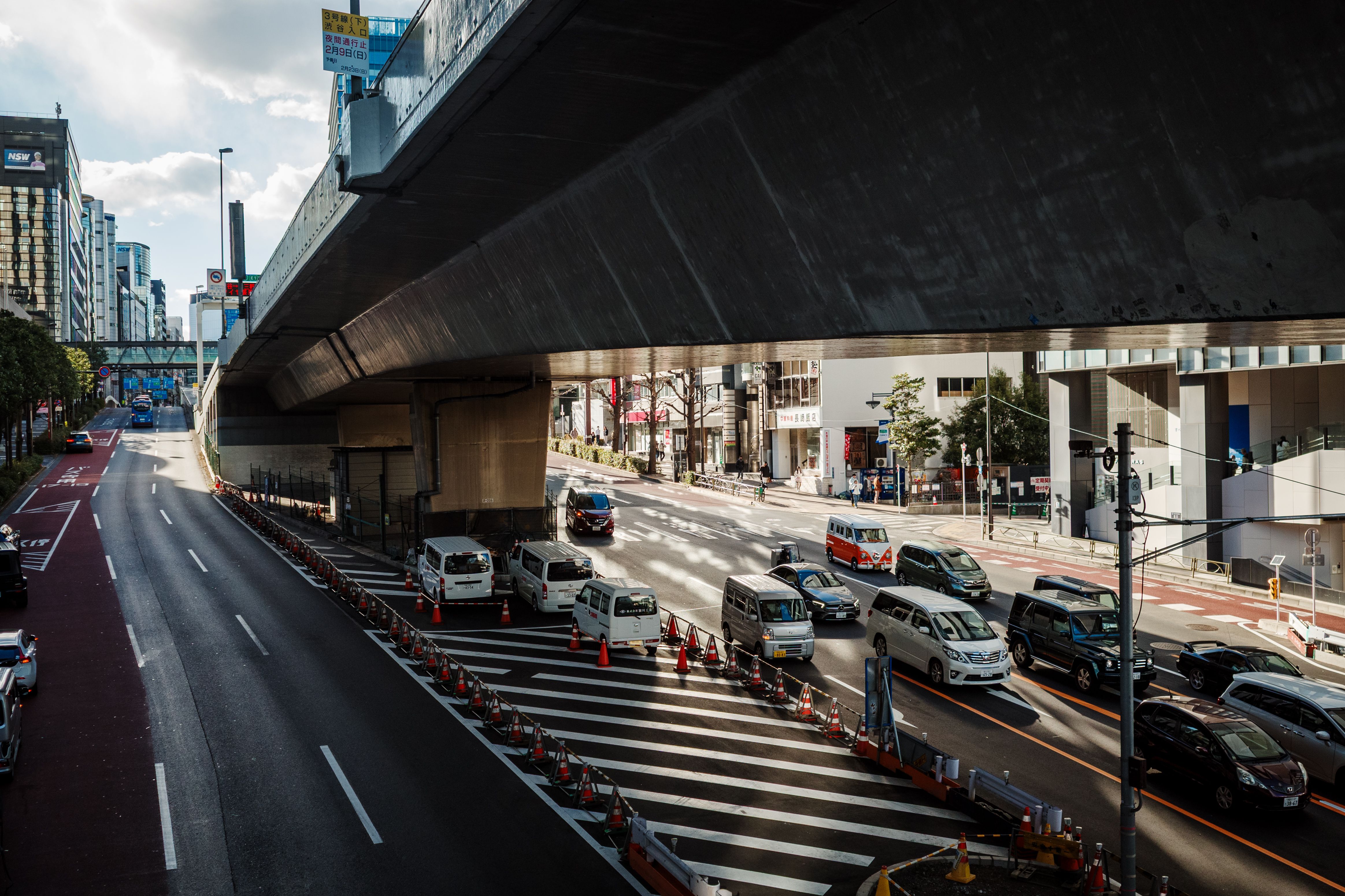 Busy Urban Street under a Highway Overpass · Free Stock Photo