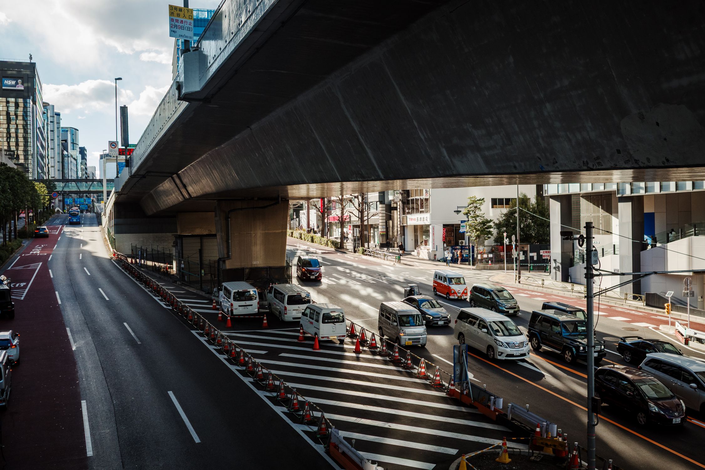 Urban/street Runder Busy Urban Street under a Highway Overpass · Free Stock Photo