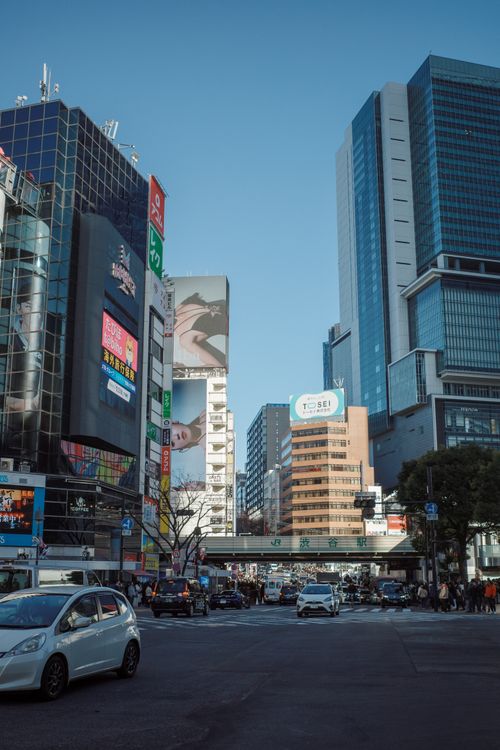 Free Busy city street in Shibuya, Tokyo with modern skyscrapers and lively atmosphere. Stock Photo