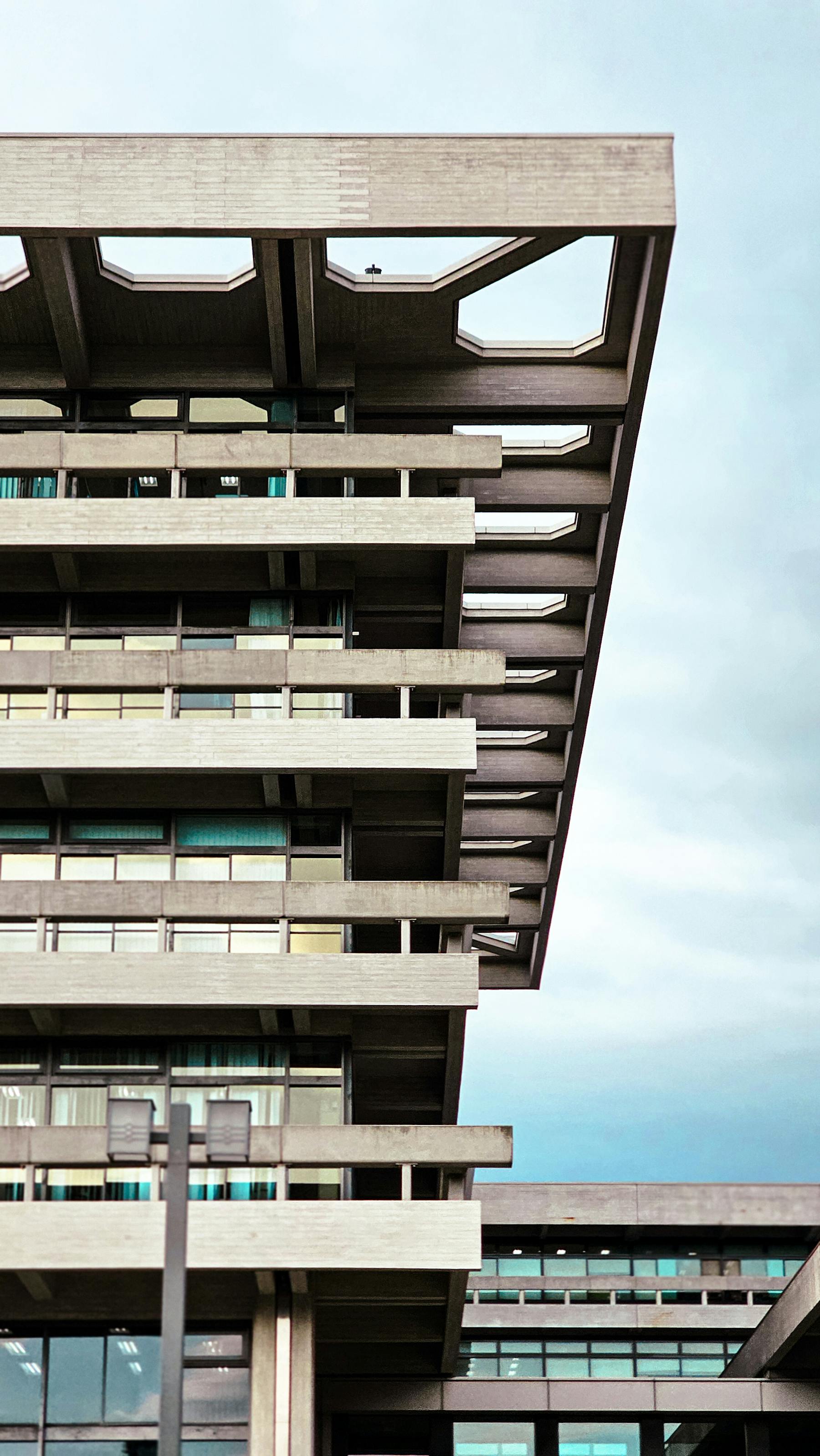 Brutalist concrete building exterior, geometric structural facade