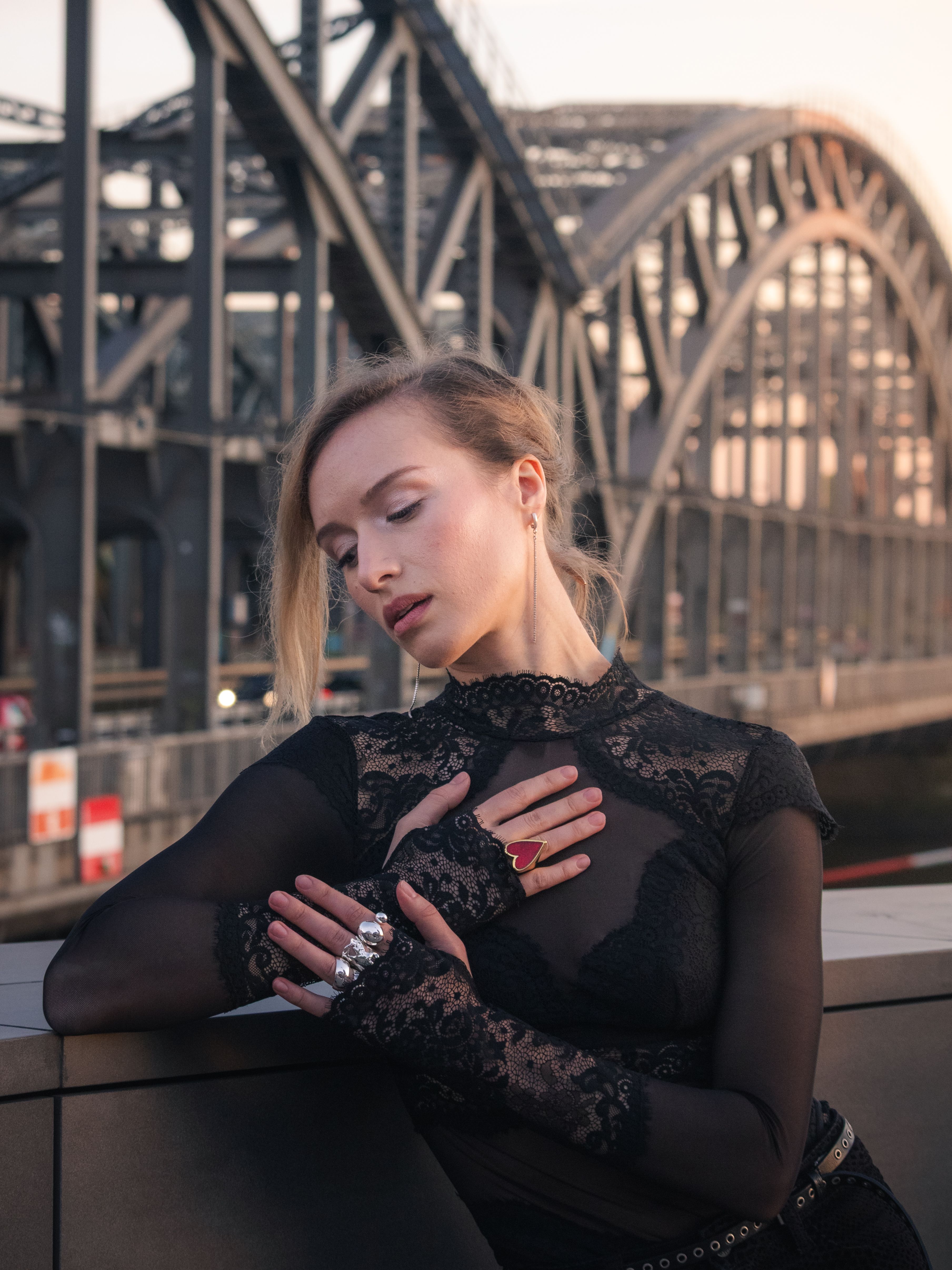 Woman Posing Elegantly in Front of Iconic Bridge · Free Stock Photo