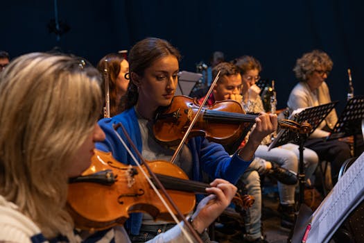Focused violinists performing in an orchestra, creating beautiful string music.