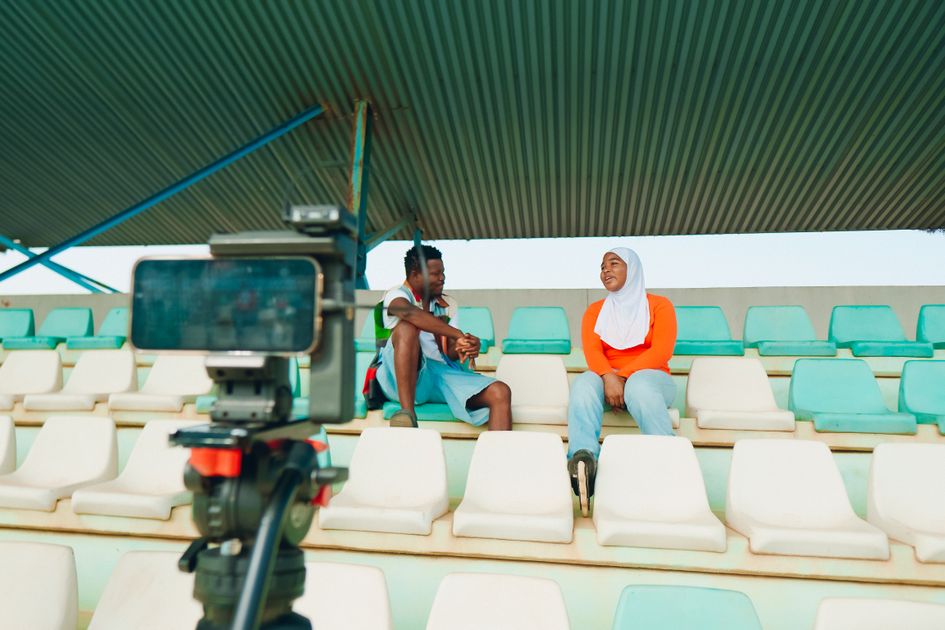 Two people conducting an emotional interview with a professional video camera setup