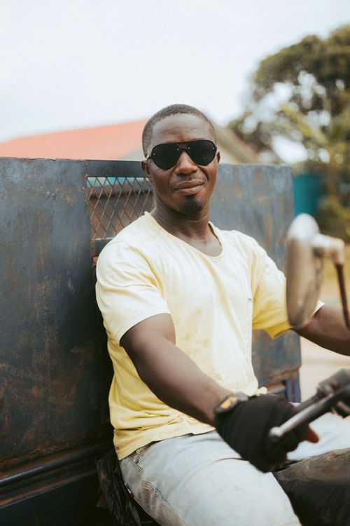 Free Smiling man in sunglasses riding a motorcycle outdoors on a sunny day. Stock Photo