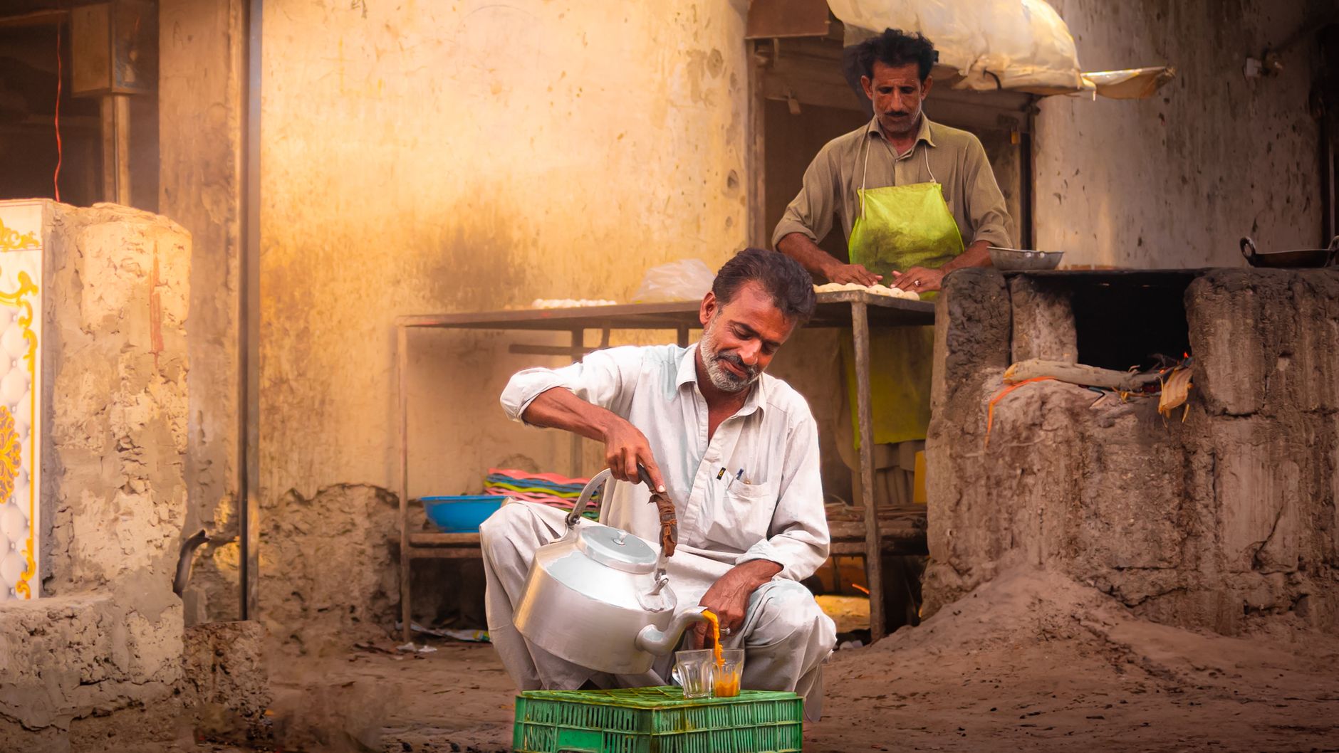A street vendor pouring tea in Turbat, Balochistan, capturing daily life in Pakistan.