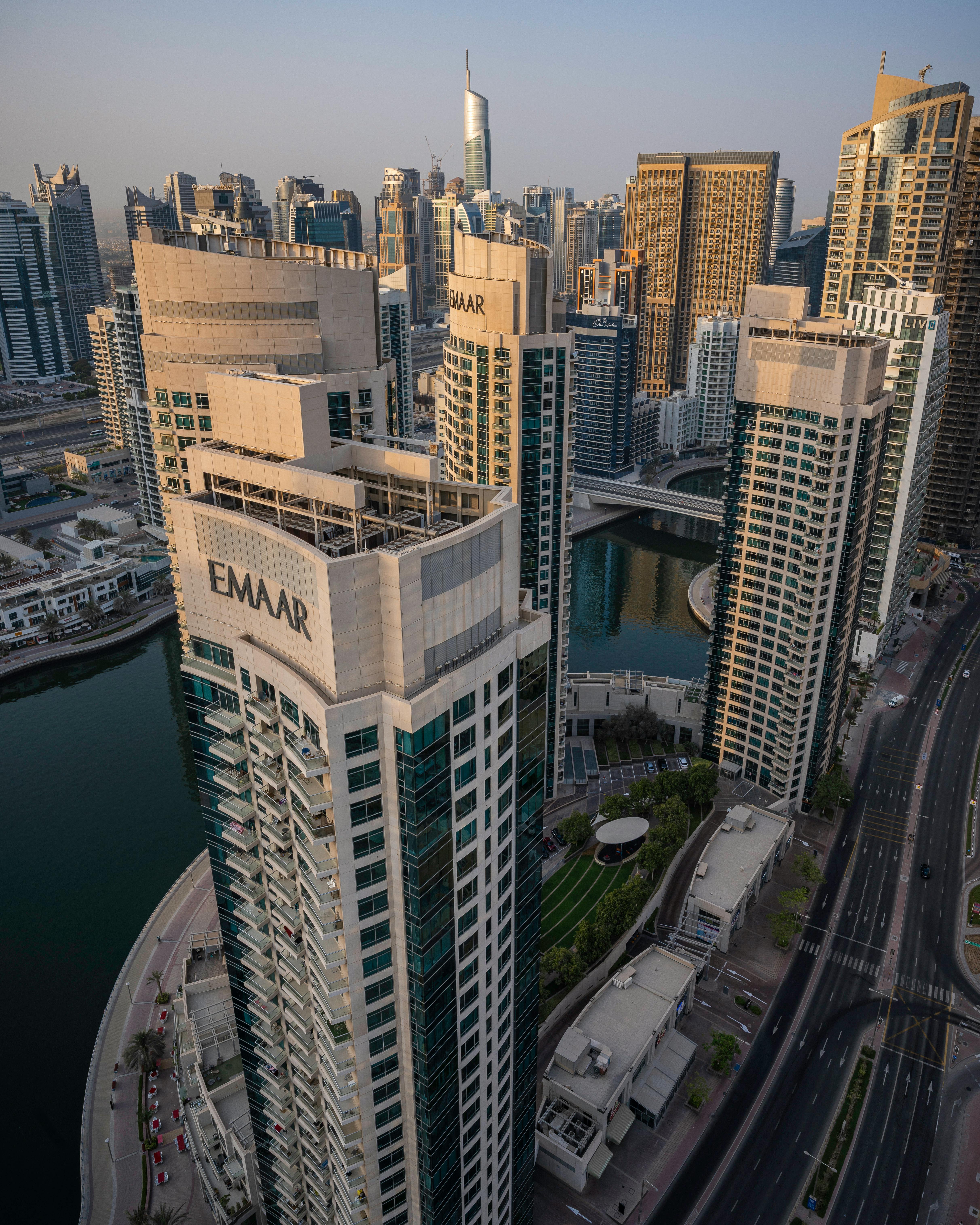 An aerial view of a modern Gulf city skyline at sunset, representing the region's rapid digital-health ambitions and the chance to write its own regulatory playbook.