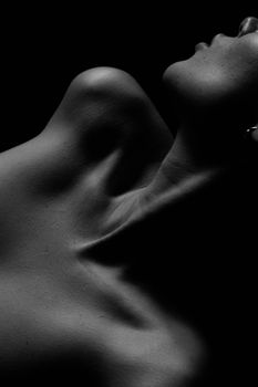 Stunning black and white nude portrait emphasizing human form and shadow play.