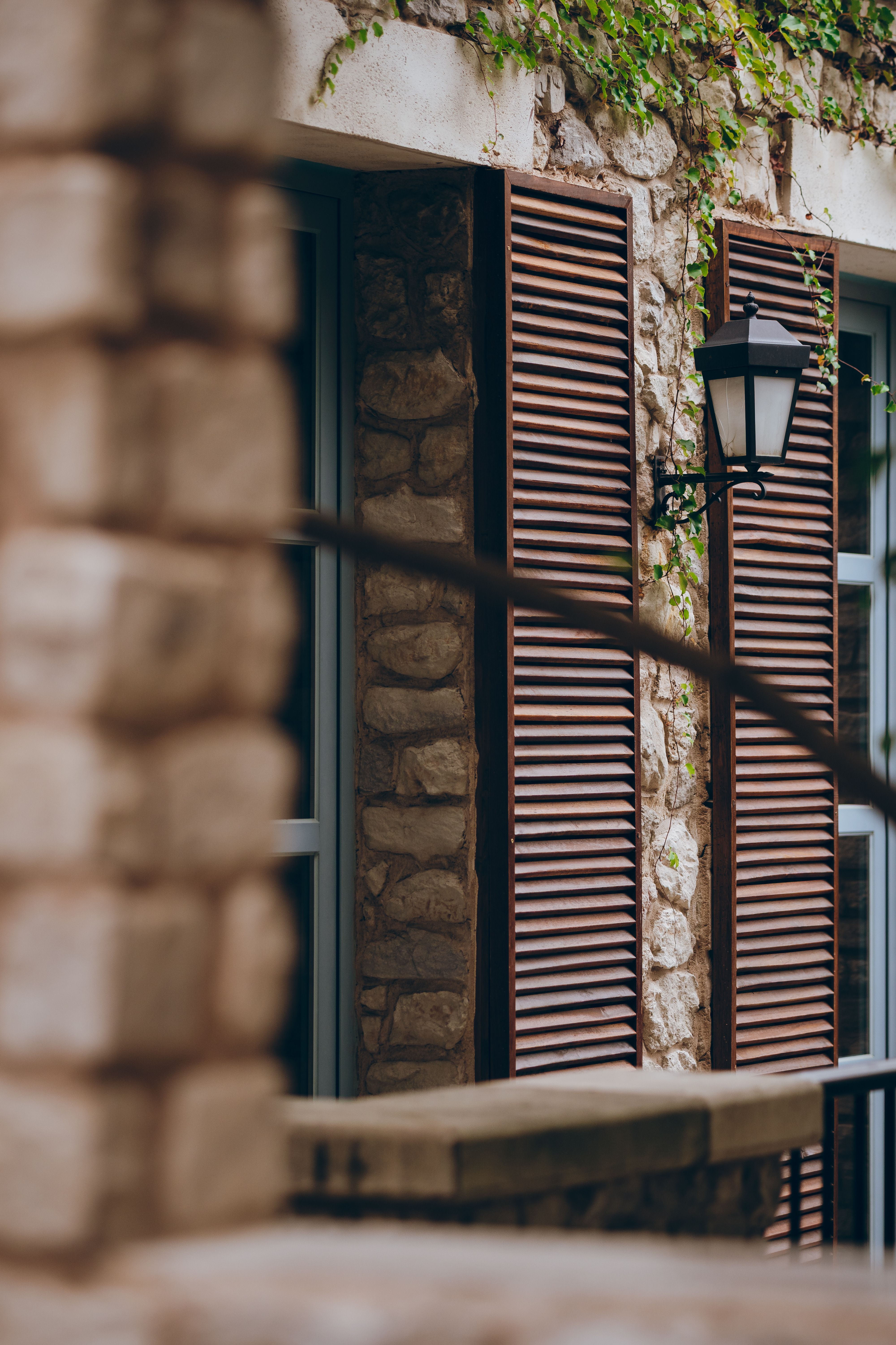 Rustic Stone Building with Wooden Shutters · Free Stock Photo