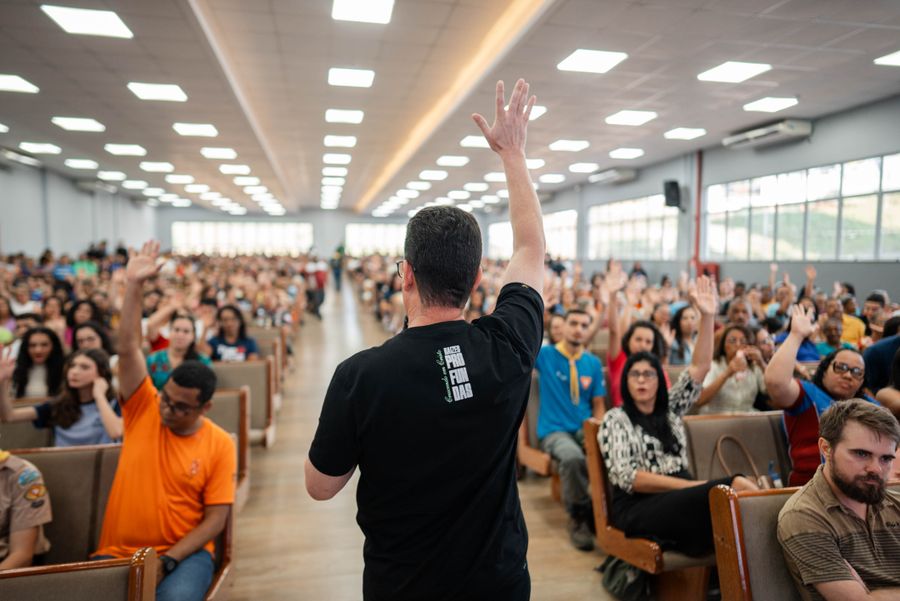 Crowd raising hands at a town hall