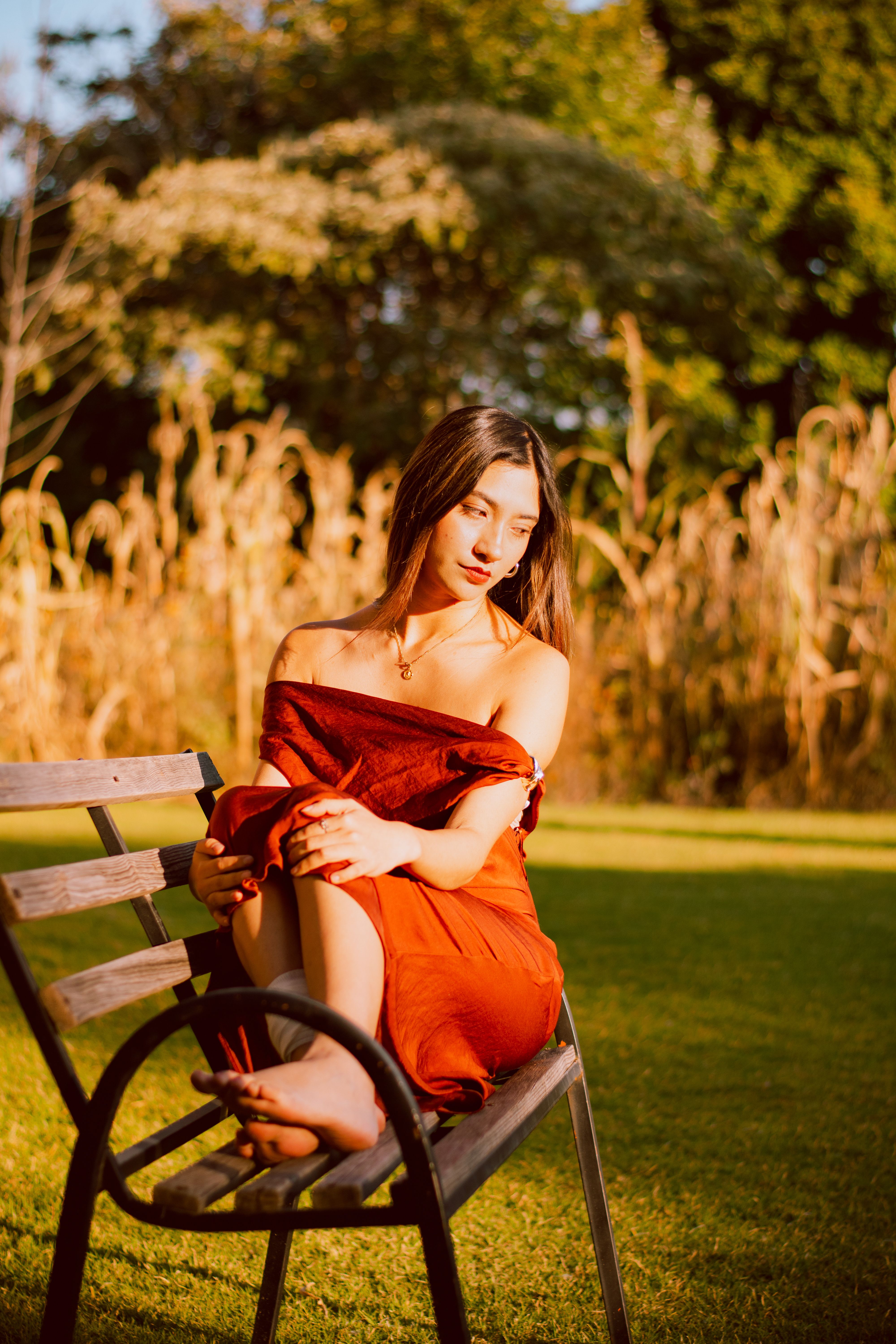 Serene Woman on Bench in Sunny Garden · Free Stock Photo