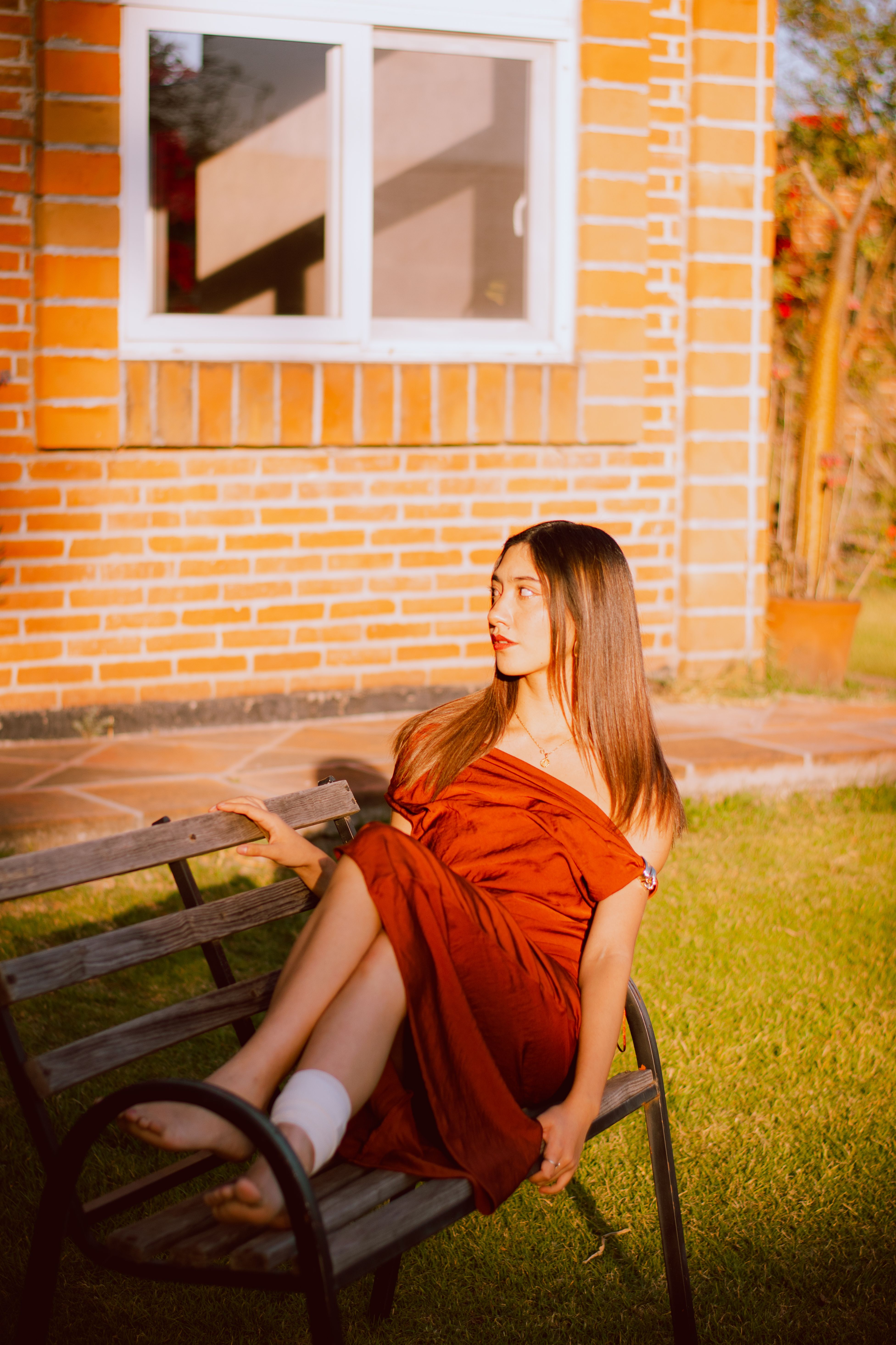 Woman in Red Dress Relaxing on Bench Outdoors · Free Stock Photo
