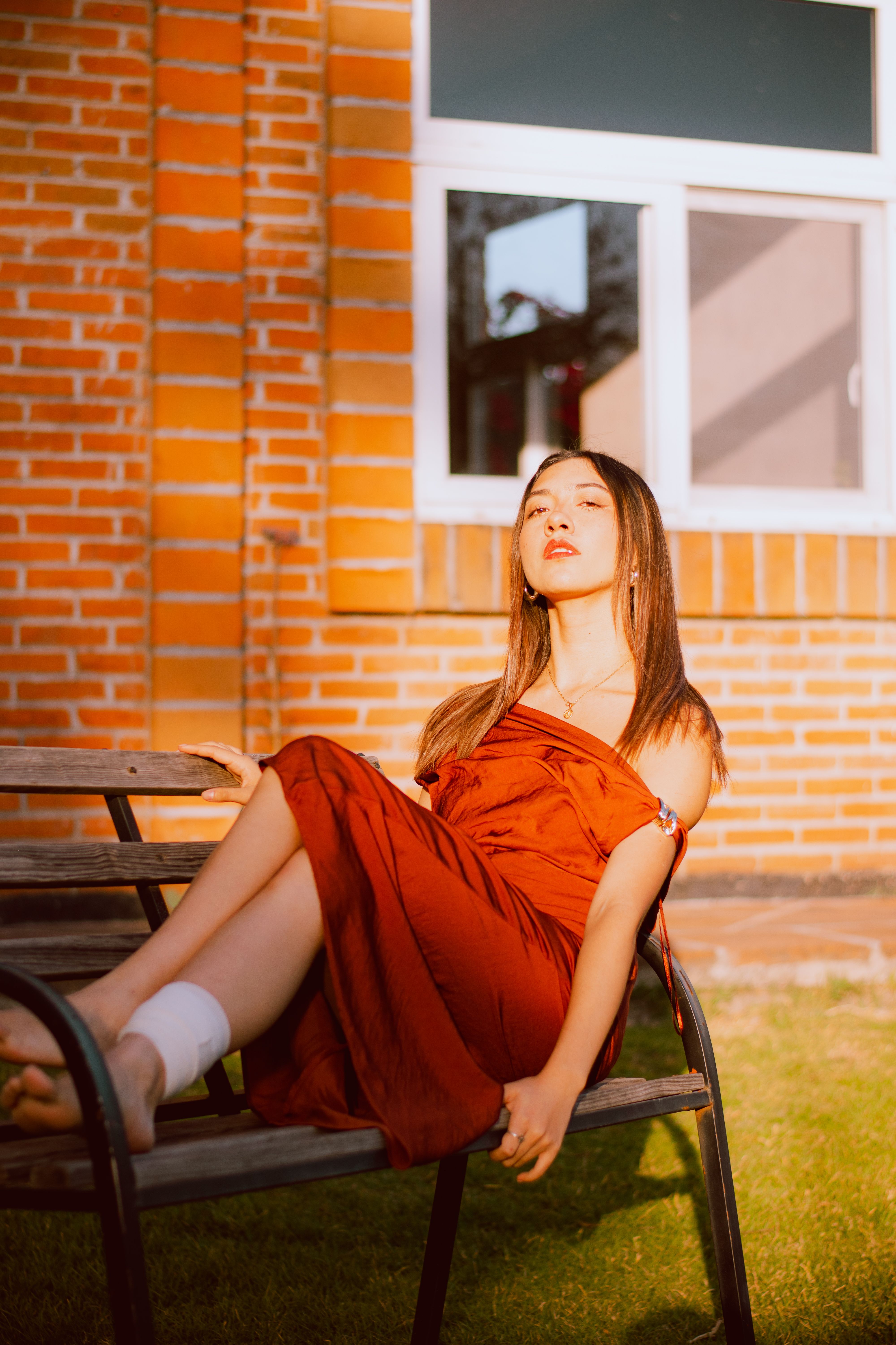 Woman in Red Dress Relaxing on Park Bench · Free Stock Photo