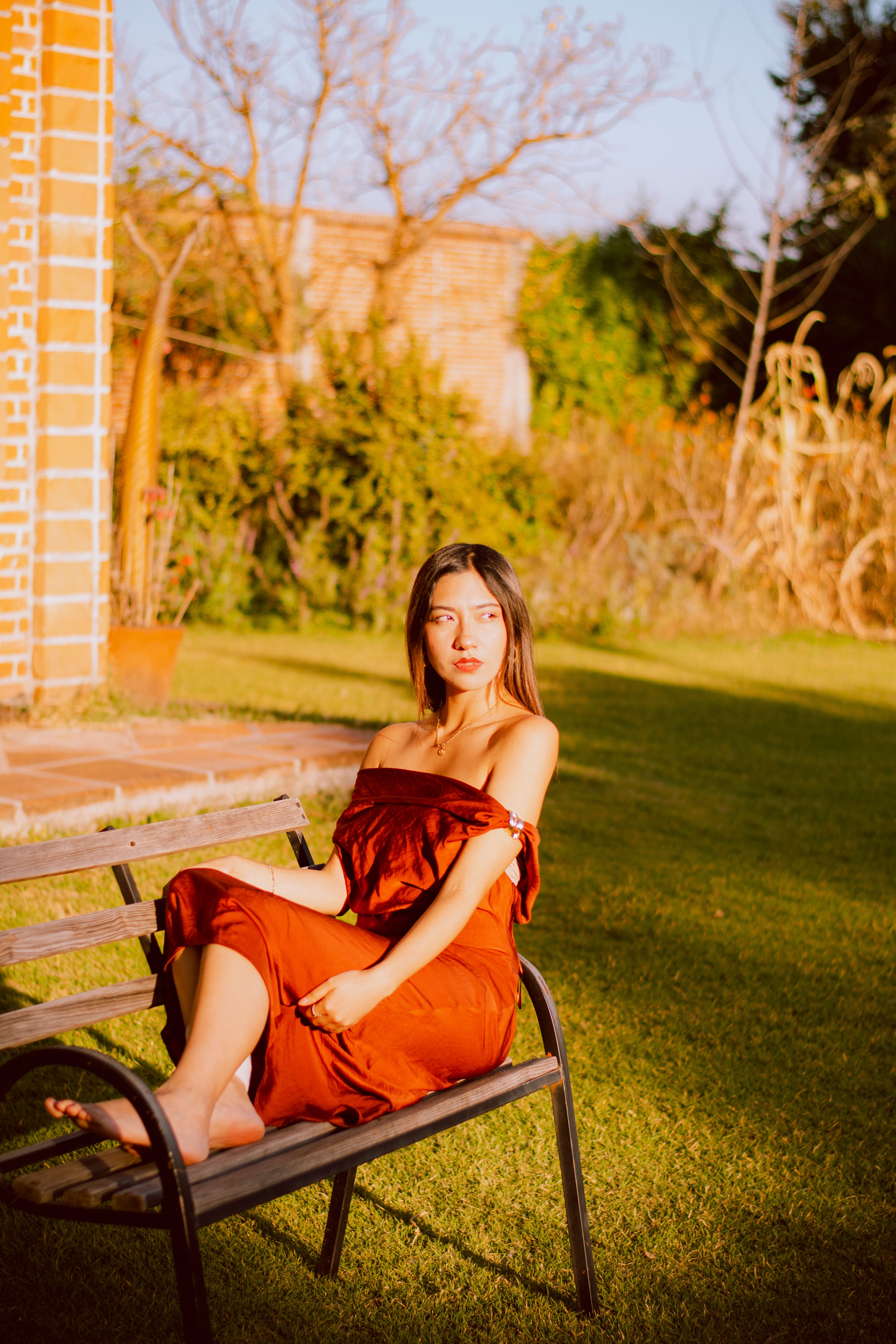 Woman in Red Dress Relaxing on Park Bench · Free Stock Photo