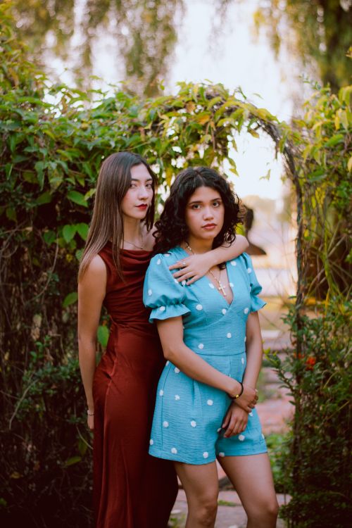 Two Women Posing in Elegant Dresses Outdoors · Free Stock Photo